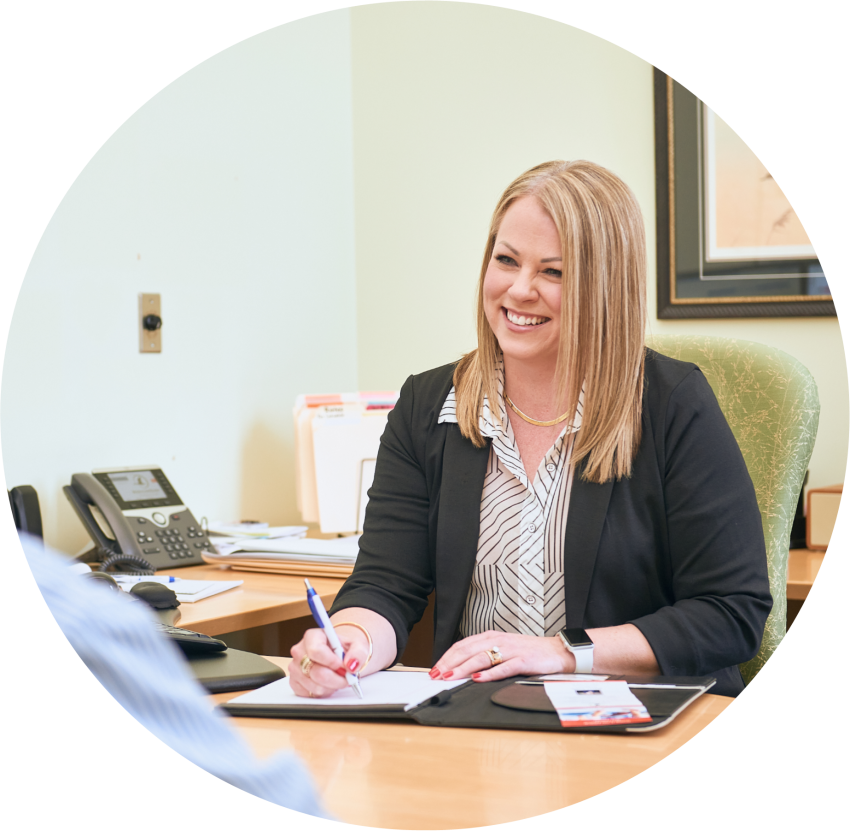 smiling banker behind a desk helping customers