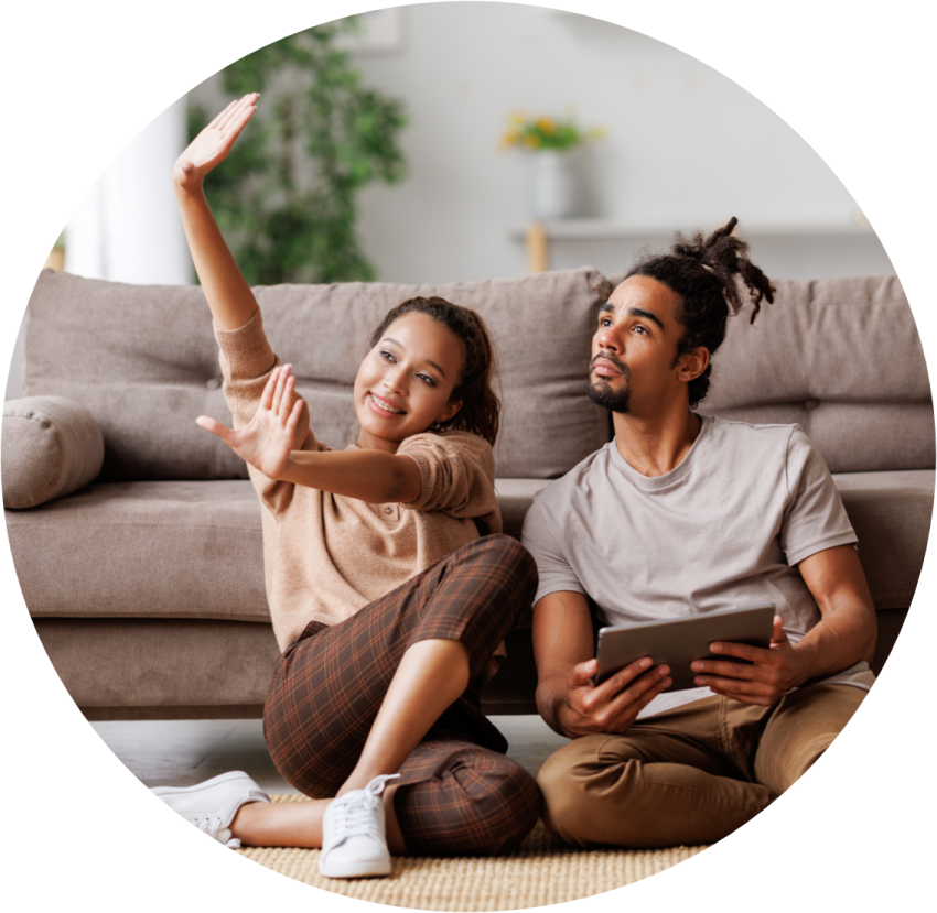 couple sitting on floor of home making plans