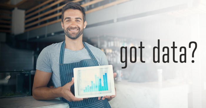 man holding tablet with charts displayed