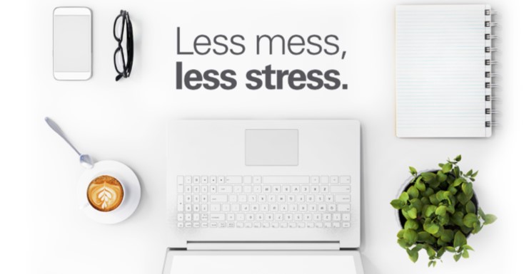 tidy white desk with laptop, phone, glasses and plants