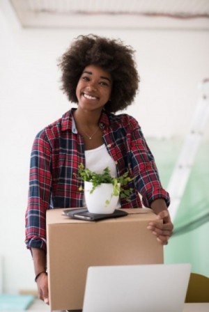 woman moving box and plant